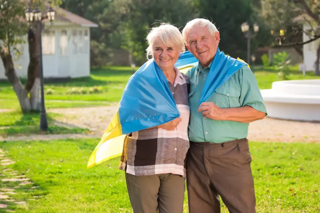 Elderly couple with Ukrainian flag.